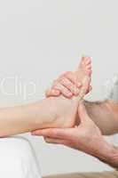 Hands of a physiotherapist massaging a foot