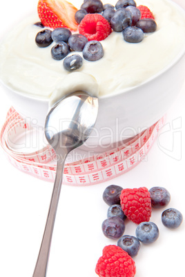 Berries cream and spoon with a tape measure
