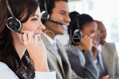 Young businesswoman working with a headset and accompanied by he