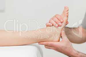 Hands of an osteopath massaging a foot