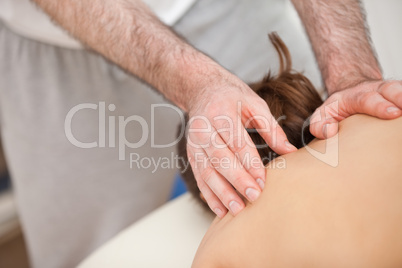 Chiropractor touching the back of his patient
