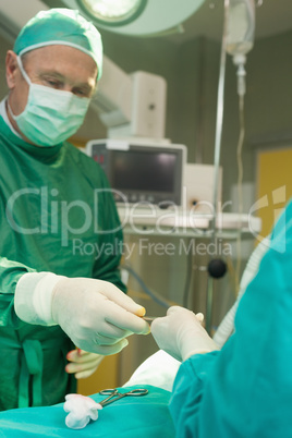 Surgeon holding scalpel during an operation