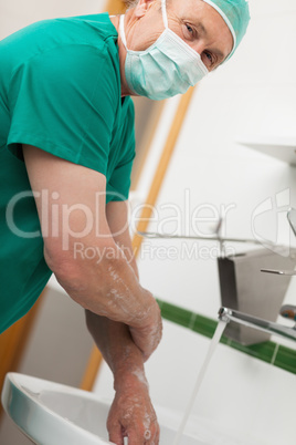 Surgeon washing hands with soap