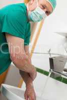 Surgeon washing hands with soap
