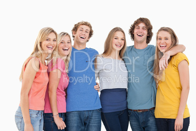 A group of friends holding each other and smiling