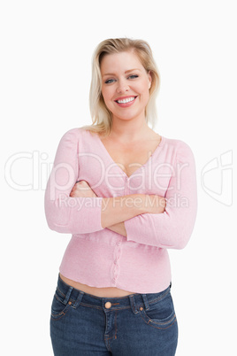 Smiling blonde crossing her arms while standing