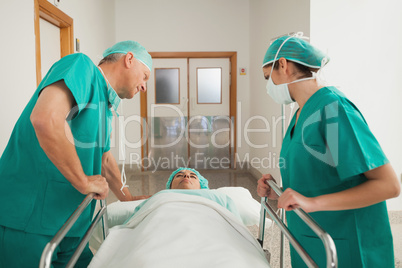 Surgeons leaning on a medical bed