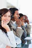 Smiling call centre agent looking at the camera while working ha