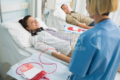 Transfused patients smiling to a nurse