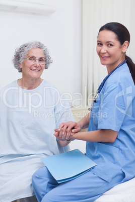 Nurse holding hand of a patient