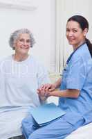 Nurse holding hand of a patient