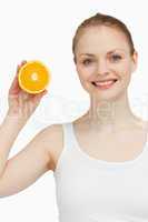 Smiling woman holding an orange