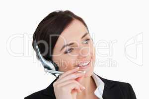 Businesswoman in black suit using a headset