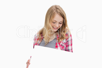 Woman holding a blank board while looking it