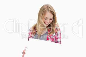 Woman holding a blank board while looking it