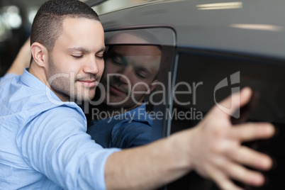 Man hugging on a car