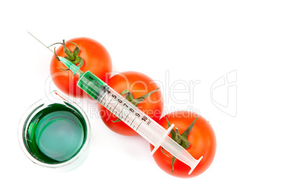 Beaker next to syringe on tomatoes