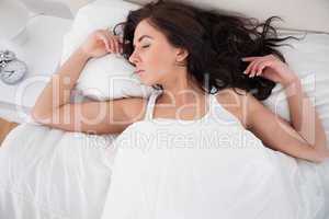 Woman sleeping in her bed in the morning