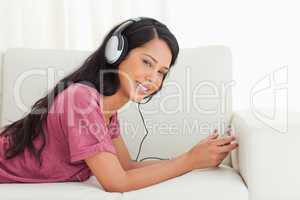 Young Latino smiling while listening to music