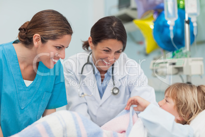Doctor and nurse looking at a child
