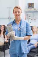 Nurse standing while holding a clipboard