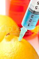 Close up of syringe into a lemon