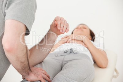 Masseur massaging the thigh of a woman