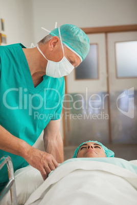 Surgeon touching a patient