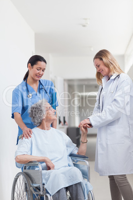 Doctor looking at a patient on a wheelchair