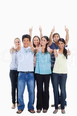People smiling together and approving with the thumbs-up