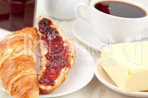 Breakfast with a croissant spread with jam