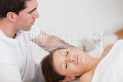 Masseur massaging the neck of his patient