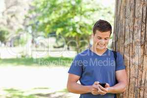 Muscled student using a smartphone