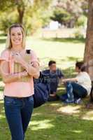 Smiling female holding a textbook