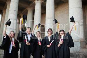 Graduates holding up their hats