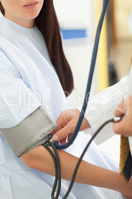 Doctor measuring the blood pressure of his patient