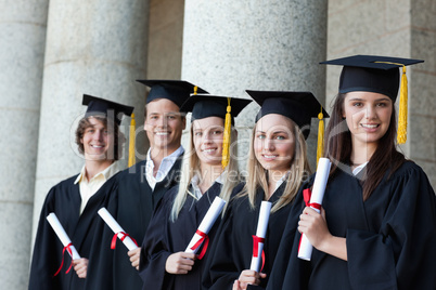 Graduates posing in single line