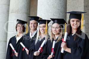 Graduates posing in single line