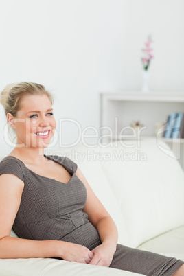 Woman sitting while holding her hands