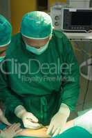 Surgeon incising a patient