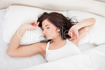 Peaceful woman stretching her body while getting up