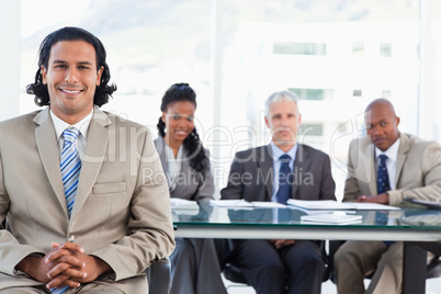 Businessman smiling while sitting with her hands crossed
