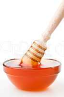 Honey dipper to the surface on  the honey bowl