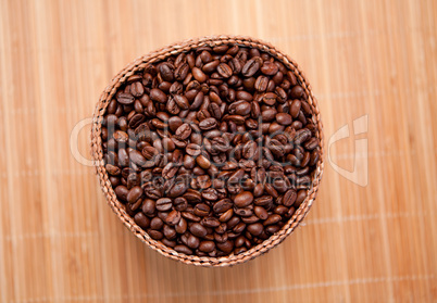 Roasted coffee seeds in a wooden basket