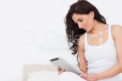 Brunette woman watching her tablet computer