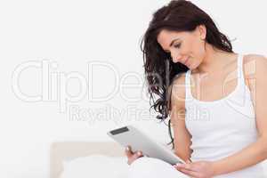 Brunette woman watching her tablet computer