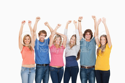 A group of people with their hands raised