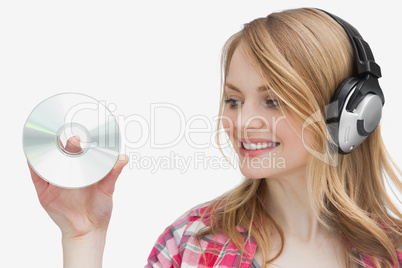 Woman holding a cd while looking it