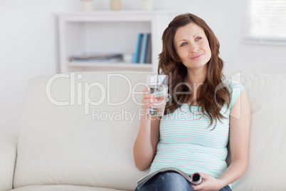 Thoughtful woman holding a glass