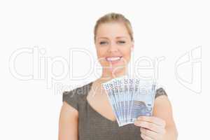 Pretty woman showing euros banknotes